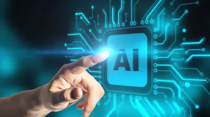 A hand touches a glowing digital interface displaying the letters "AI," surrounded by circuit-like lines representing artificial intelligence technology.
