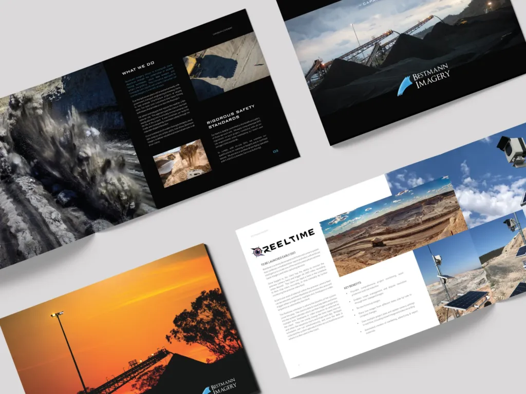 Four open brochures display mining and industrial site photos, text about services, safety standards, and equipment, with a focus on Bestmann Imagery and Reeltime.